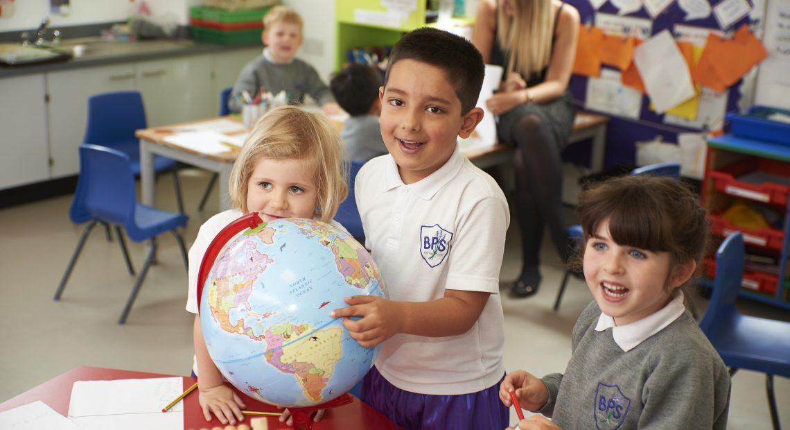 children holding a globe