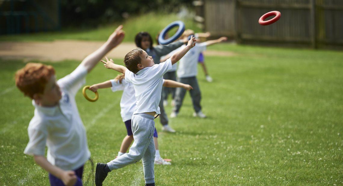 children throwing hoops