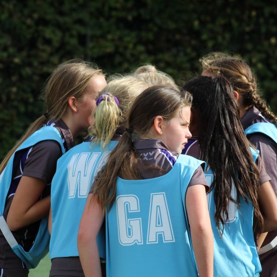 group of netball girls in a huddle