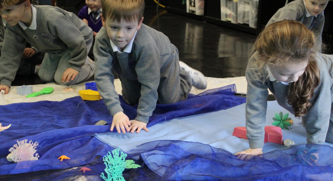 children placing materials on the floor