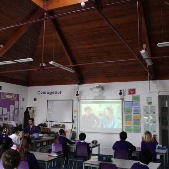 children watching a video on a board