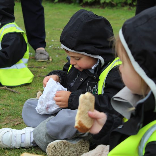 Students eating sandwiches outside