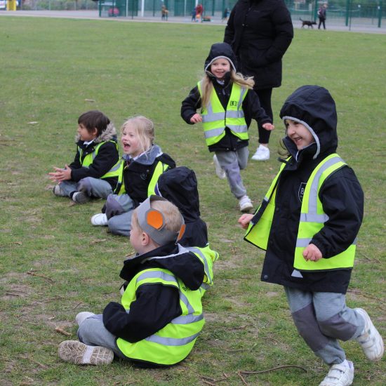 Children running across the pitch