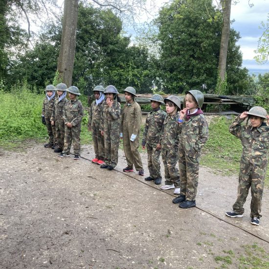 children dressed in army gear standing in a line