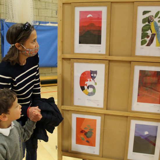 a boy viewing artwork with his mum