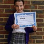 Hollie stood with her maths certificate