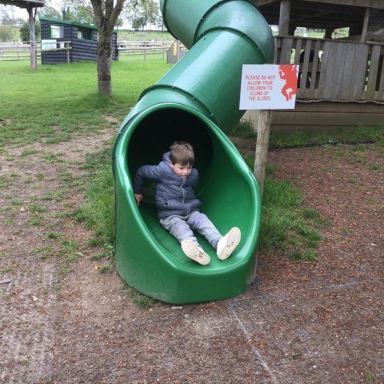 a boy coming down a slide