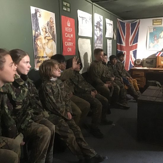children sitting in an army cabin