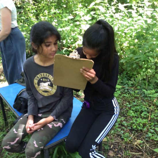 children using a clip board outdoors