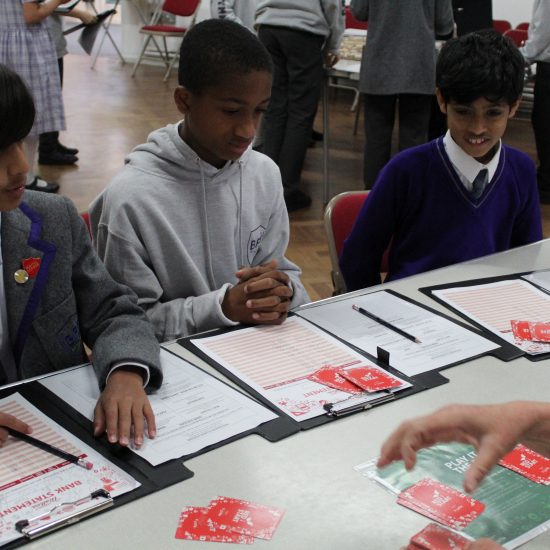 boys from an independent school in Surrey with clip boards