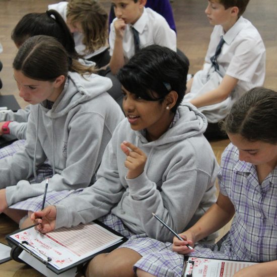 children from an independent school in Surrey with clipboards