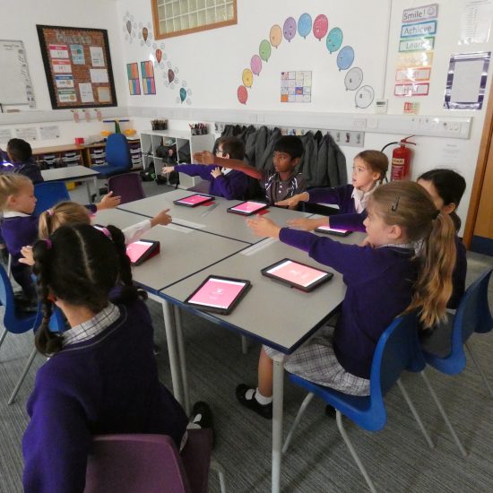 children using ipads in the classroom at a private school in surrey