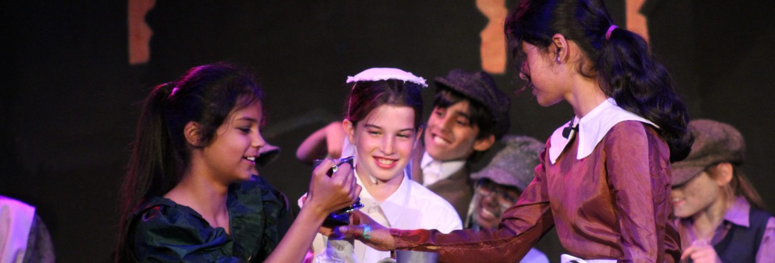 Students acting in the Oliver! Jr production