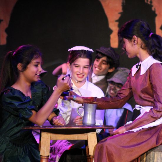 Students acting in the Oliver! Jr production