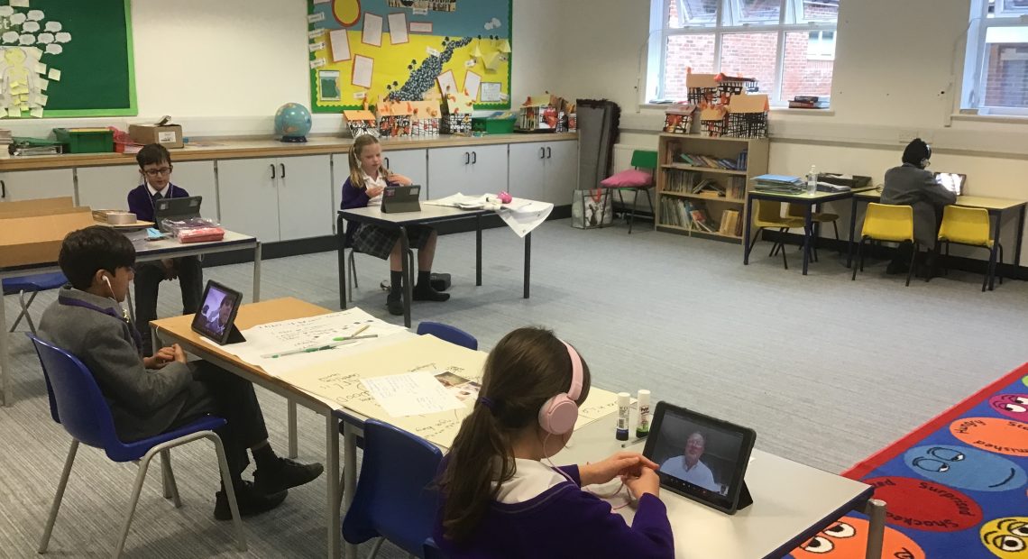 Students speaking to teachers over an iPad