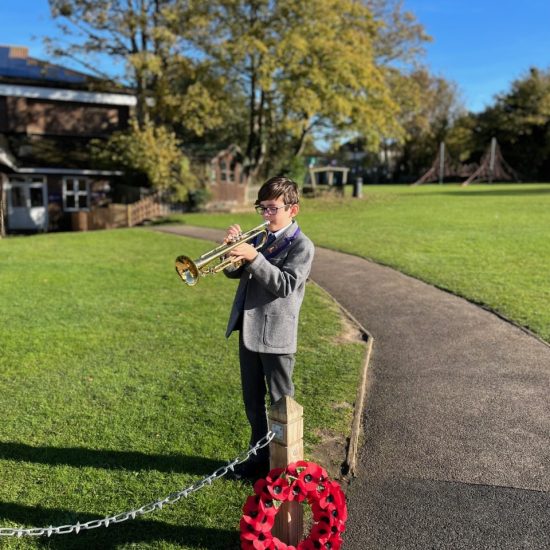 A boy from a prep school in Surrey blowing a trumpet