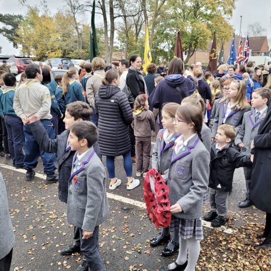 children from a prep school in Surrey holding a poppy wreath
