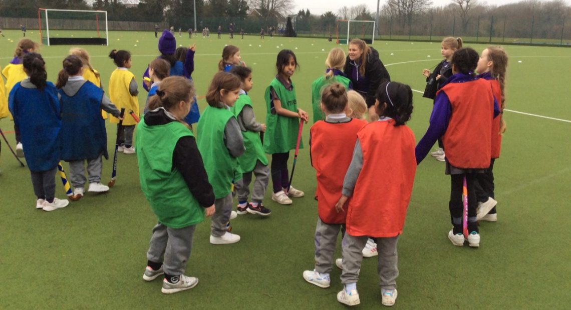 Students on the astro turf for a game of hockey
