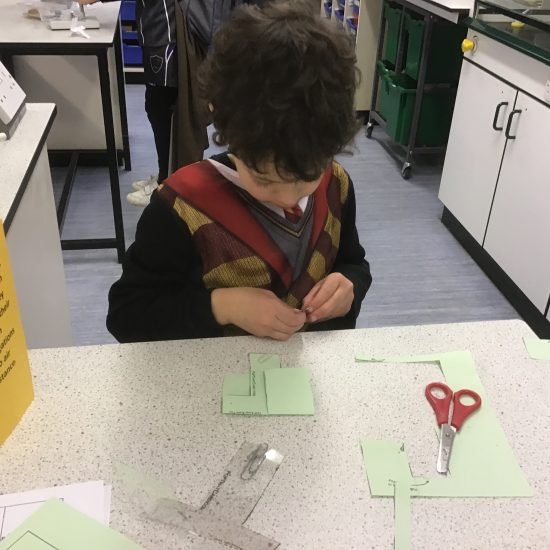 student cutting things out with scissors