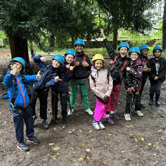 group of children in protective clothing for climbing