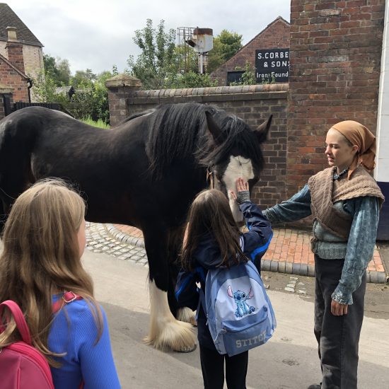 students petting a horse
