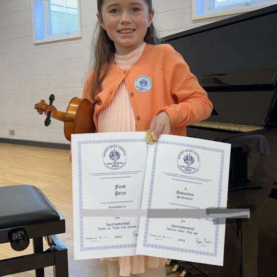 girl holding award