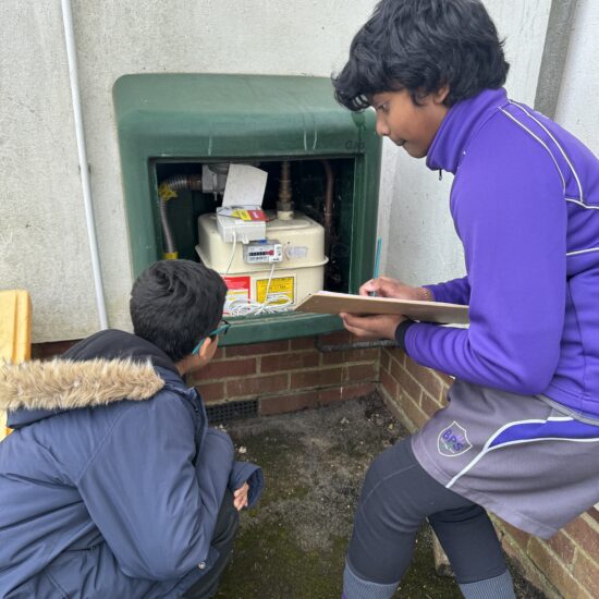 students looking at an electric box