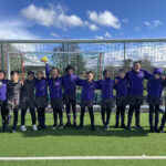 students in front of a football net