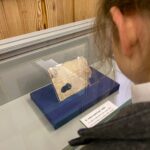 A pupil looking at a £1m banknote from the 1800s on display in a glass case at the Bank of England museum